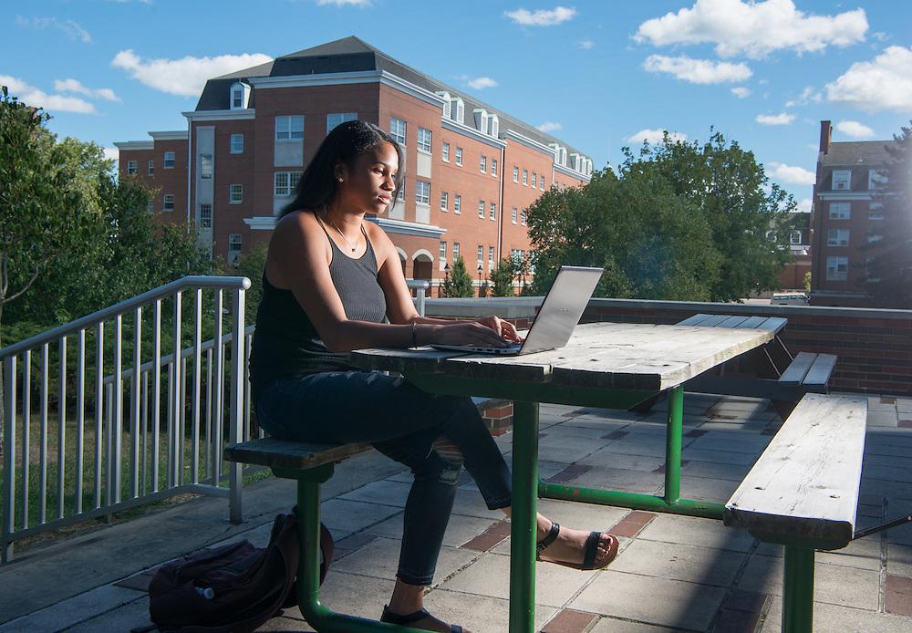 Student outside on a laptop